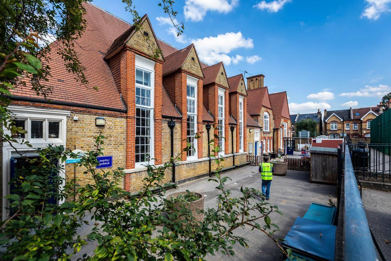 Mitie worker in a high-vis vest visiting a school building